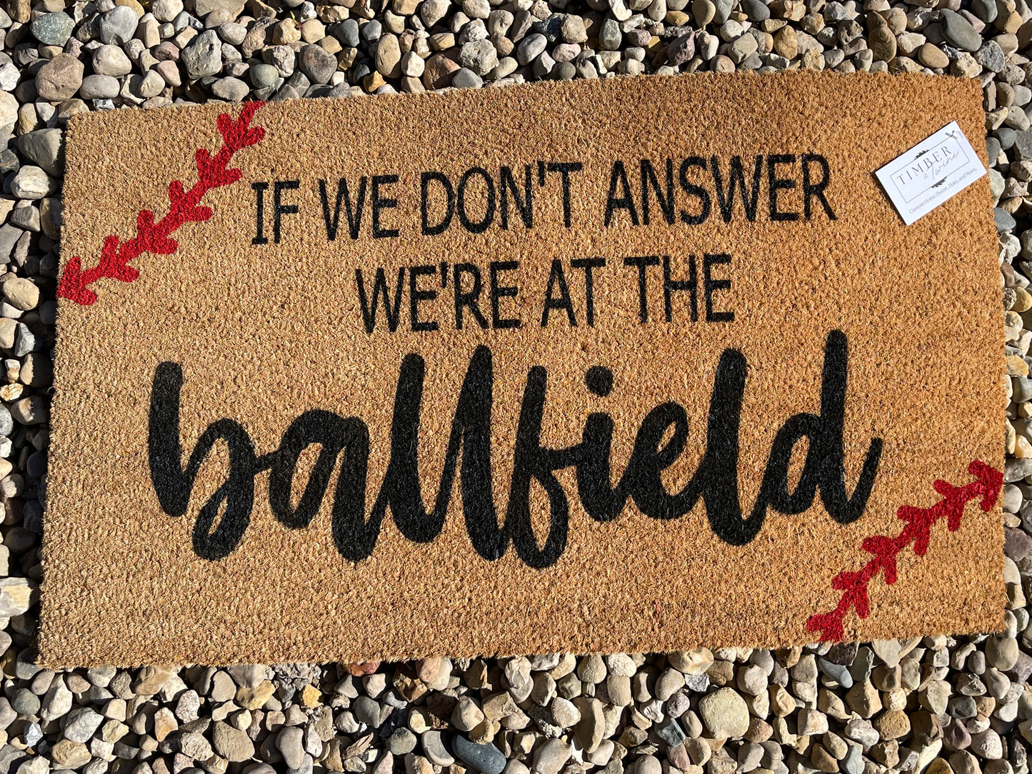 If We Don't Answer, We're At The Ball Field Doormat by Timber & Twine